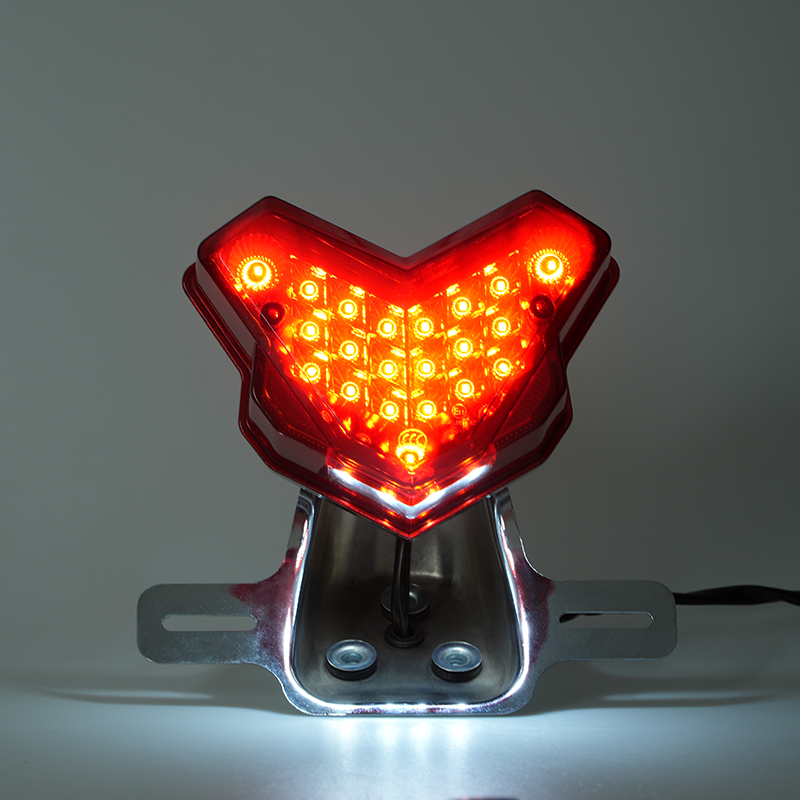 Motorcycle V style LED tail light illuminated, red brake rear light with chrome mounting bracket, lighting demo