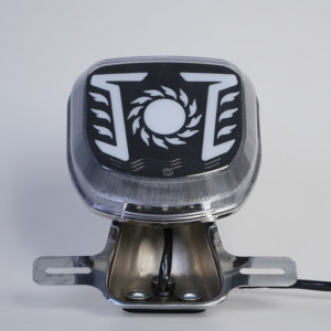 Customizable logo motorcycle rear LED tail lamp, sun flame graphic, clear outer cover, chrome mounting holder front view