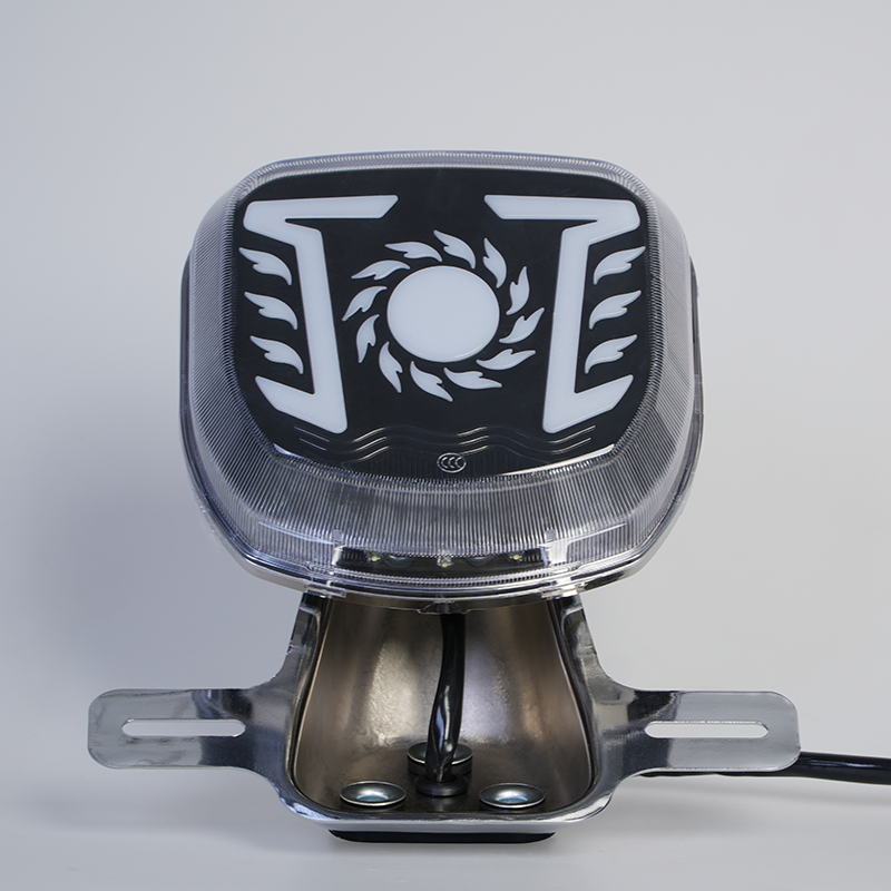 Customizable logo motorcycle rear LED tail lamp, sun flame graphic, clear outer cover, chrome mounting holder front view