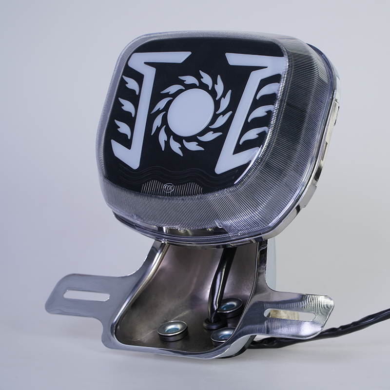 Sun flame pattern motorcycle LED tail light, black smoked inner lens, chrome license plate bracket, blank center circle for custom logo printing, side view