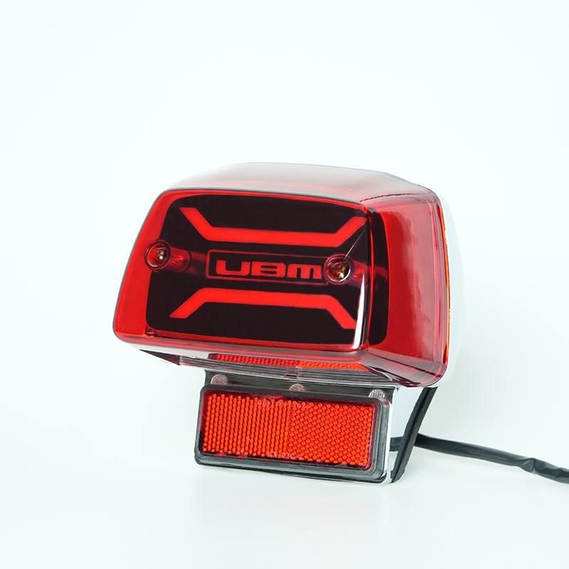 GN125 motorcycle LED tail light side view, customizable logo pattern on black panel, red lens rear brake lamp