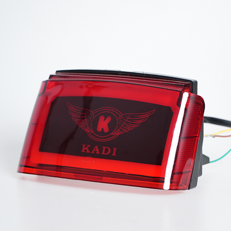 Side‑angle shot of red lens motorcycle tail lamp, customizable logo surface, static off state