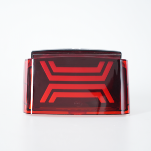 Front static shot of red transparent motorcycle taillight, double‑layer geometric decorative pattern