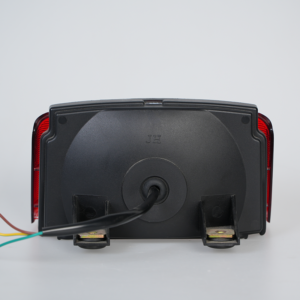 Back view of red lens motorcycle LED tail light, mounting brackets and wiring harness