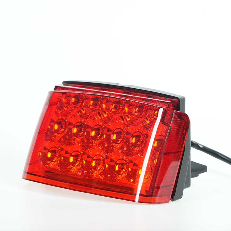 Side‑angle shot of red lens full‑LED motorcycle tail light, multi‑bulb array design, power‑off status